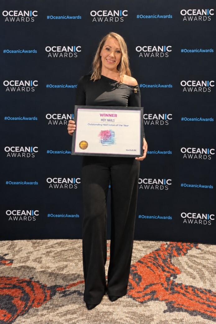 Joanna of Moy Nails holding her Outstanding Nail Salon of the Year award