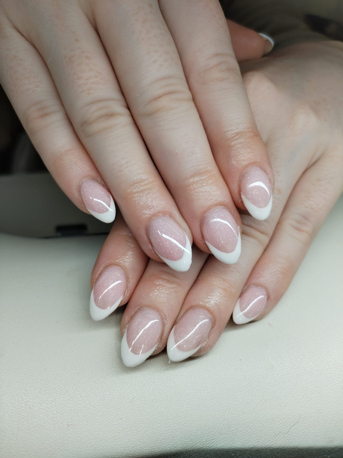 Soft shimmer manicure with curved white French tips by Moy Nails